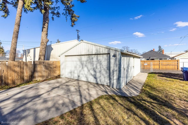 detached garage featuring fence