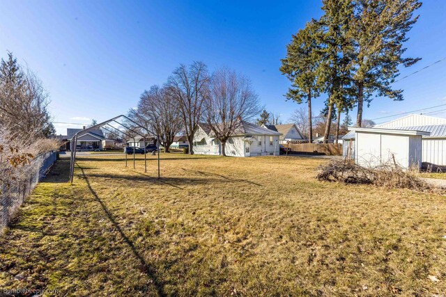 view of yard with a residential view and fence