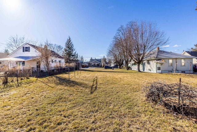 view of yard featuring a residential view and fence