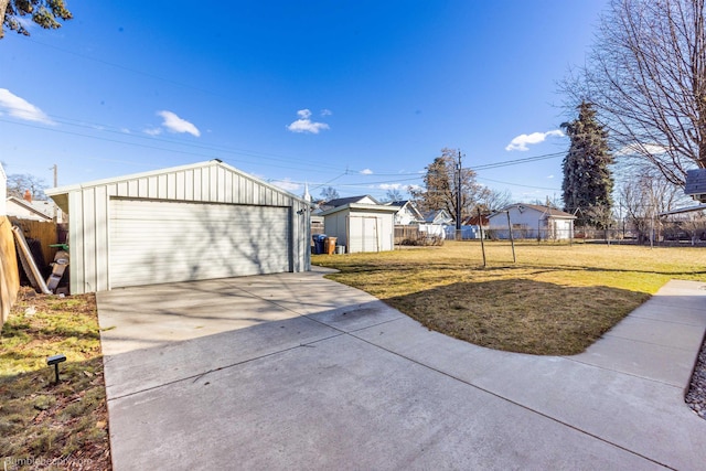 exterior space with an outbuilding, fence, and a detached garage