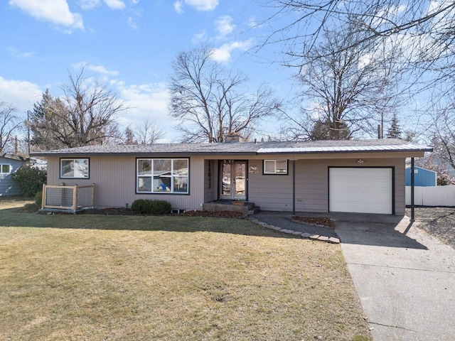 ranch-style home with a garage, fence, driveway, a front lawn, and a chimney