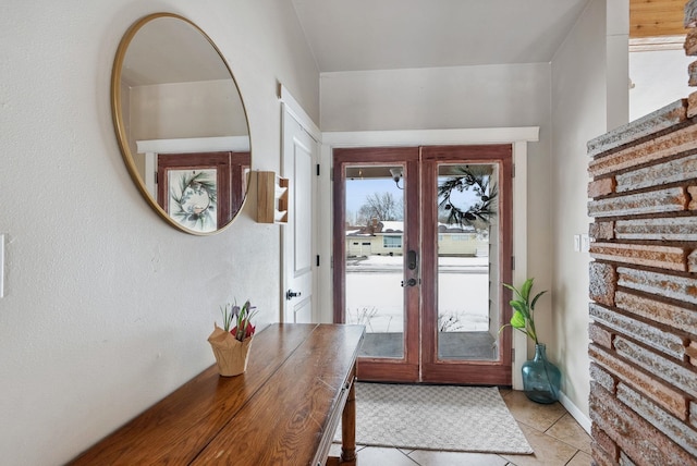 doorway with light tile patterned flooring and french doors