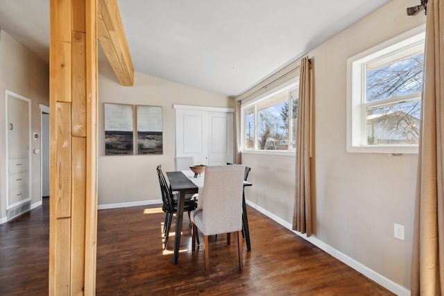 dining room with dark wood-type flooring, vaulted ceiling with beams, and baseboards