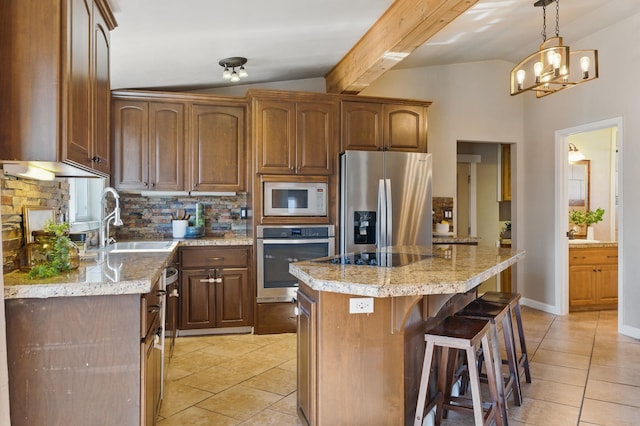 kitchen with light tile patterned floors, stainless steel appliances, vaulted ceiling, and a sink