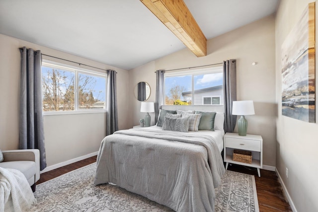 bedroom featuring lofted ceiling with beams, baseboards, and wood finished floors