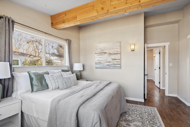 bedroom with wood finished floors and baseboards