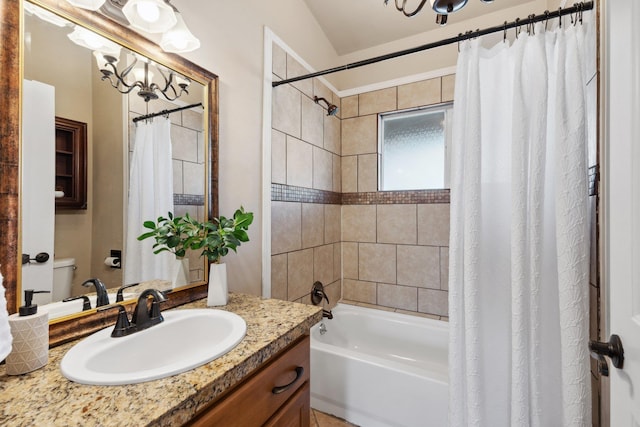 bathroom featuring toilet, shower / bath combo, and vanity