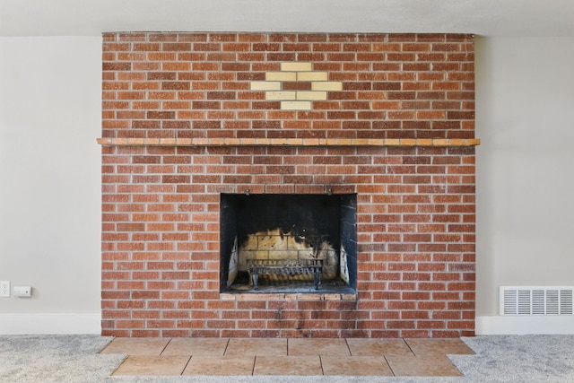 details featuring a brick fireplace and visible vents