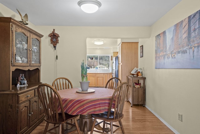 dining room with baseboards and wood finished floors