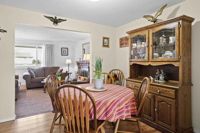 dining room featuring light wood-type flooring and baseboards