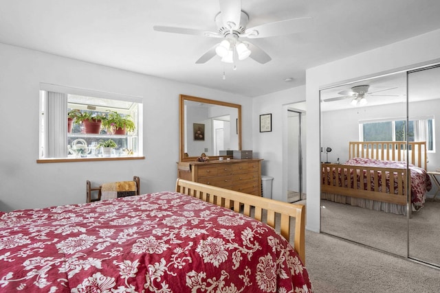 carpeted bedroom featuring a ceiling fan and a closet