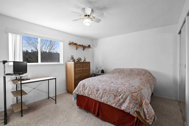 bedroom featuring carpet floors, ceiling fan, baseboards, and a closet