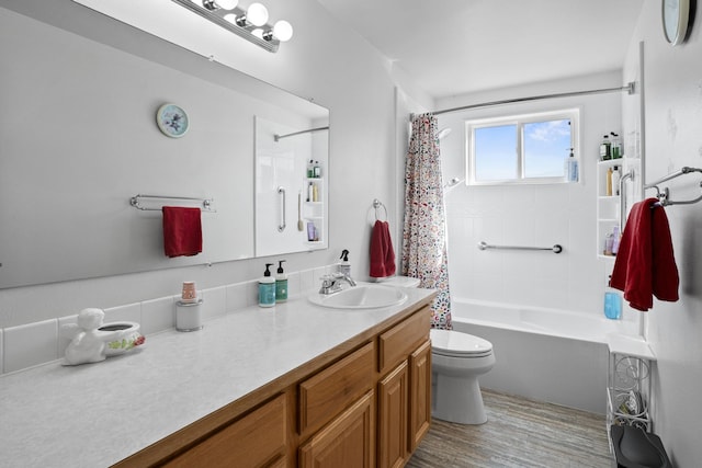 full bath featuring wood finished floors, vanity, toilet, and shower / bath combo with shower curtain