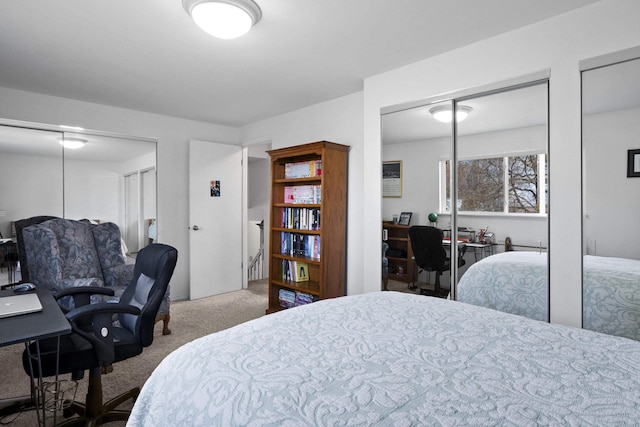 carpeted bedroom featuring two closets