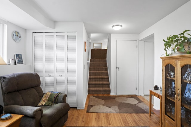 living area featuring stairs and wood finished floors