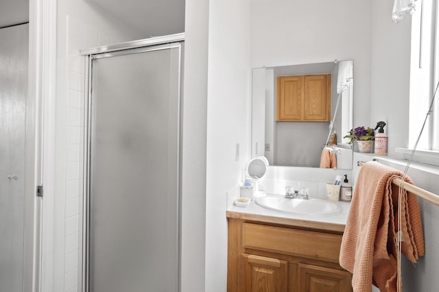 bathroom with a shower stall and vanity