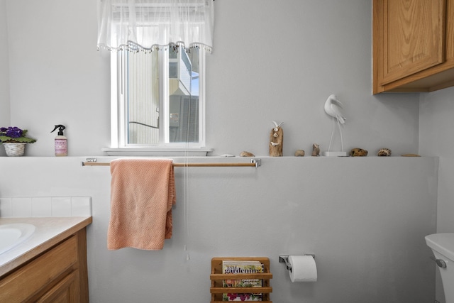 half bathroom featuring toilet and vanity