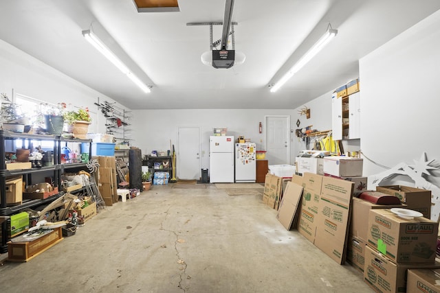 garage with freestanding refrigerator and a garage door opener