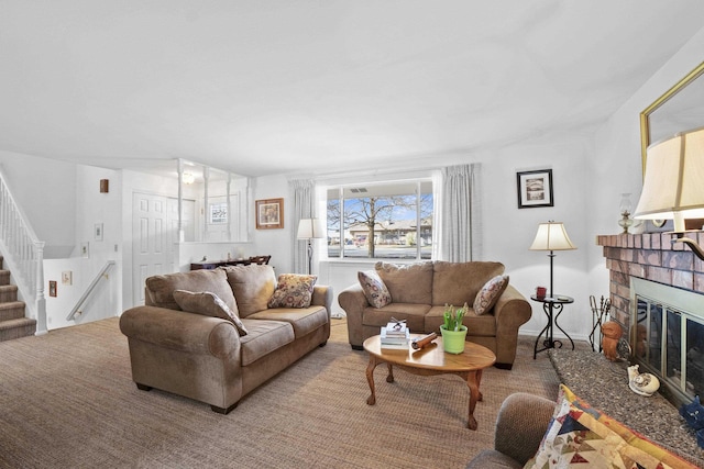 living room with a brick fireplace and stairs