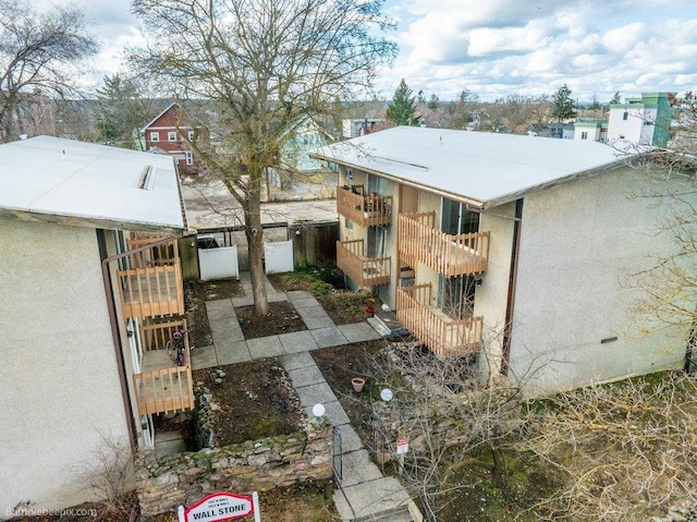 view of property exterior featuring fence, a gate, and stucco siding