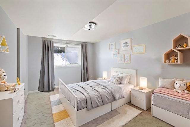 bedroom featuring baseboards, visible vents, and light colored carpet