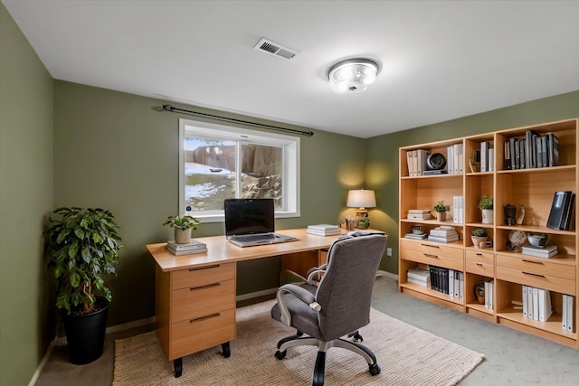 home office featuring light colored carpet, visible vents, and baseboards