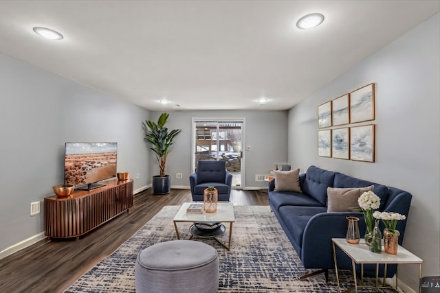 living room with baseboards and wood finished floors