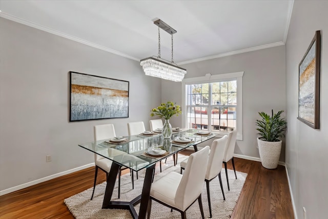 dining area with baseboards, ornamental molding, and wood finished floors