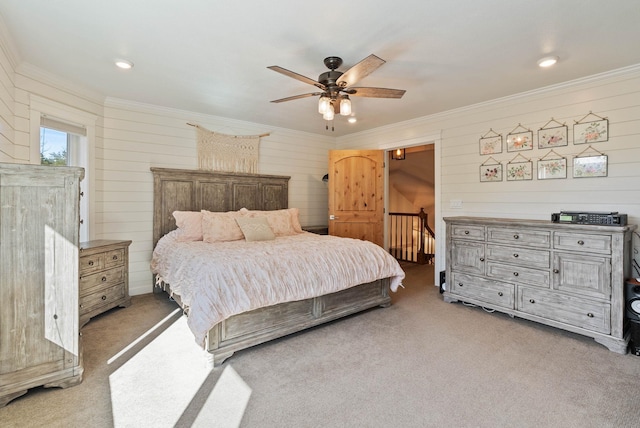 bedroom with ornamental molding, light colored carpet, and ceiling fan