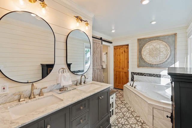 full bath with double vanity, crown molding, a tub with jets, and a sink