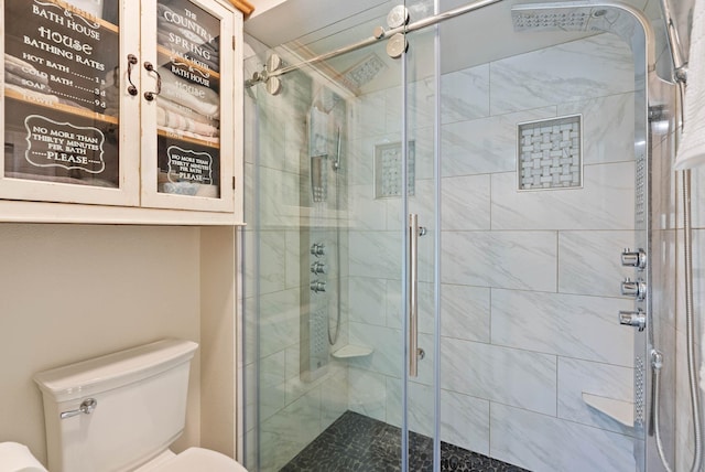 full bathroom with a stall shower and toilet