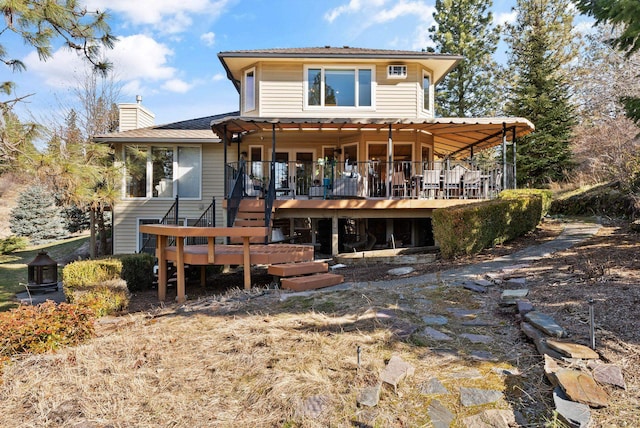 view of front facade with a chimney and a wooden deck