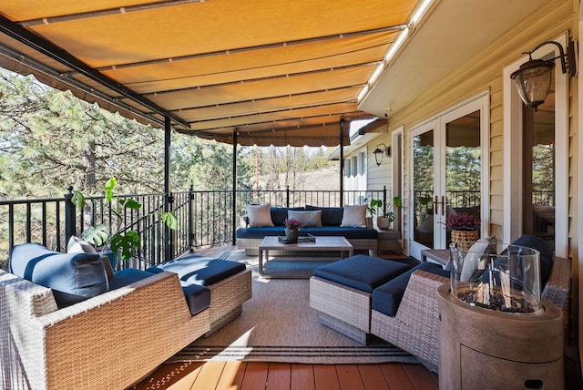 wooden terrace with french doors and outdoor lounge area