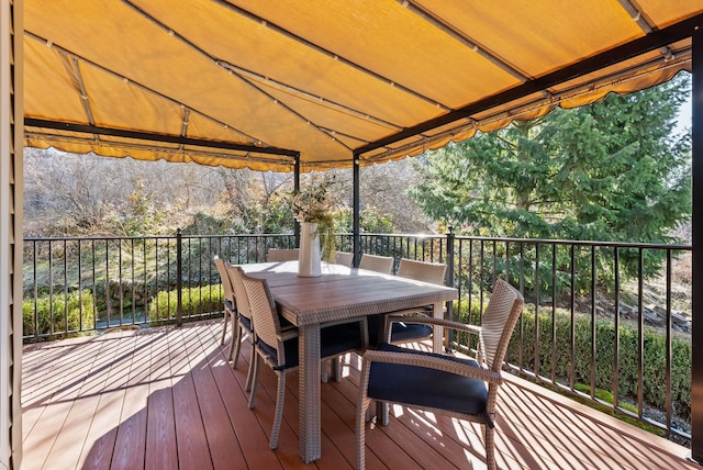 wooden terrace featuring outdoor dining area