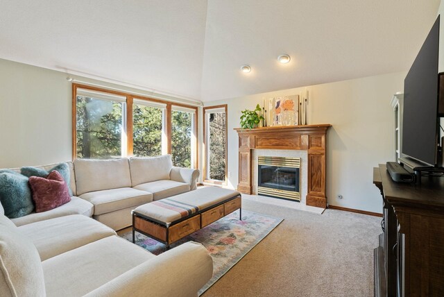 carpeted living room featuring high vaulted ceiling, a fireplace, and baseboards