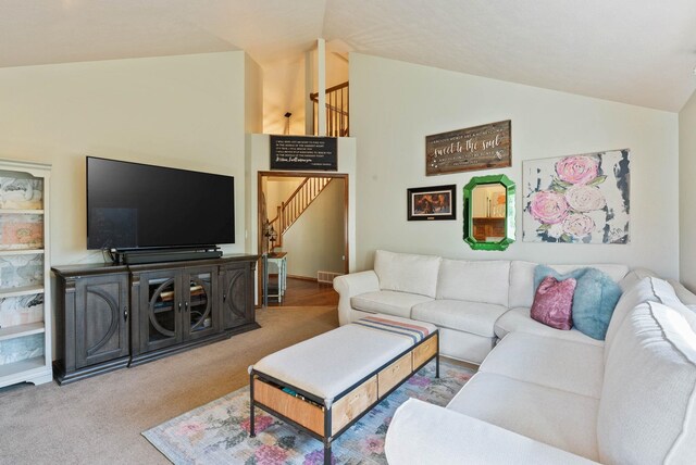 living area with carpet, vaulted ceiling, and stairs