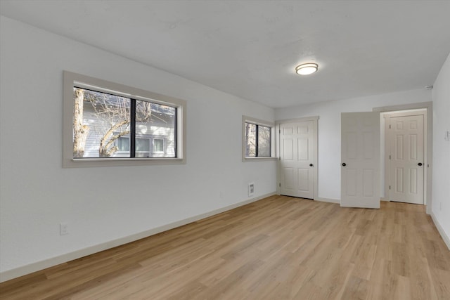 unfurnished bedroom with light wood-style floors and baseboards