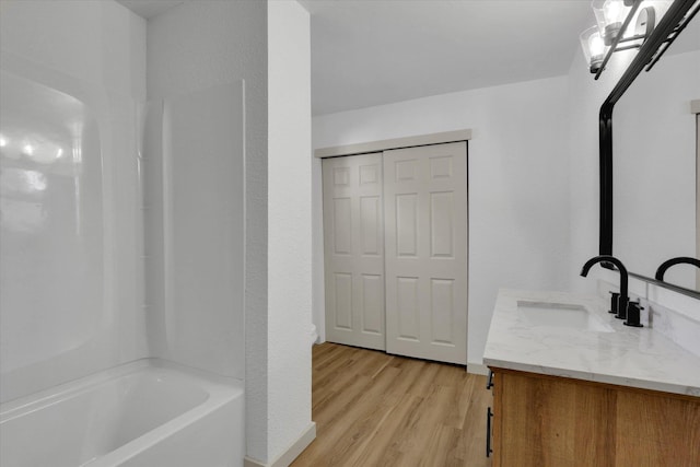 bathroom with wood finished floors and vanity