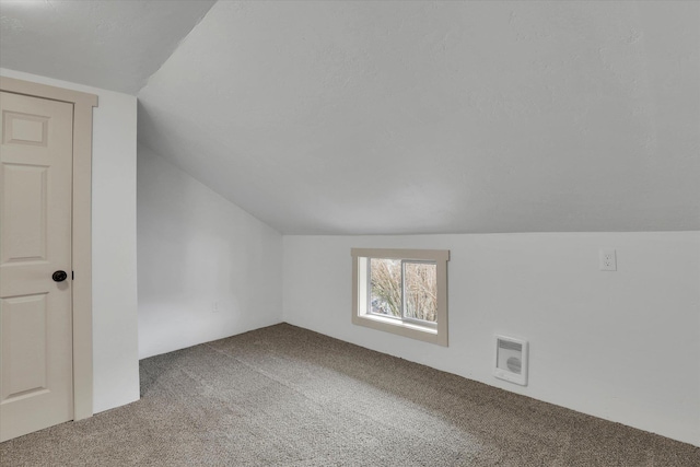 bonus room featuring heating unit, carpet, and lofted ceiling