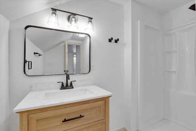 full bath with lofted ceiling, walk in shower, and vanity