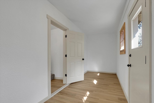 entryway with light wood-style flooring and baseboards