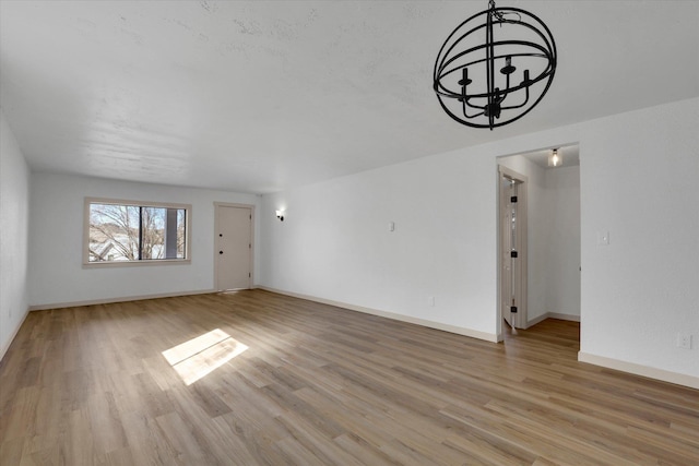 unfurnished living room featuring light wood-style flooring and baseboards