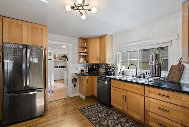 kitchen with dishwasher, separate washer and dryer, freestanding refrigerator, open shelves, and a sink