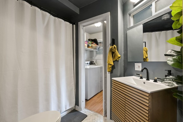 full bathroom featuring washer and dryer, vanity, toilet, and wood finished floors