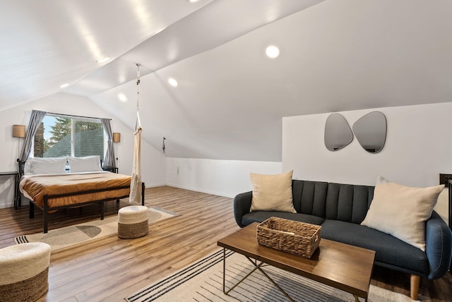 interior space with lofted ceiling, baseboards, wood finished floors, and recessed lighting