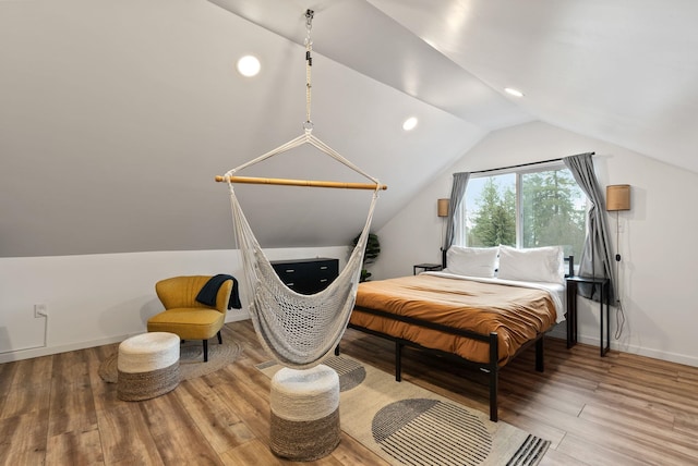 bedroom featuring lofted ceiling, recessed lighting, wood finished floors, and baseboards