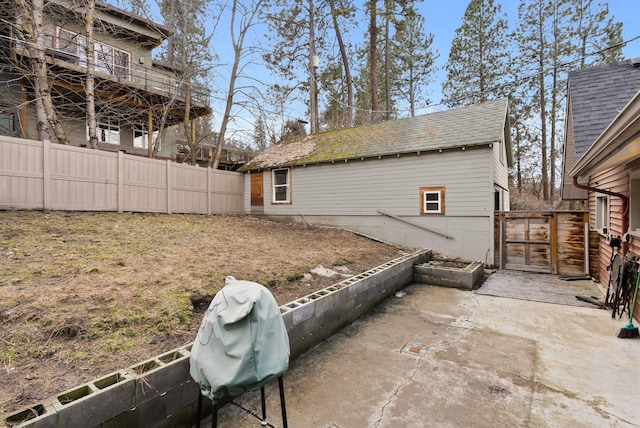 view of yard featuring a patio, fence, and a gate