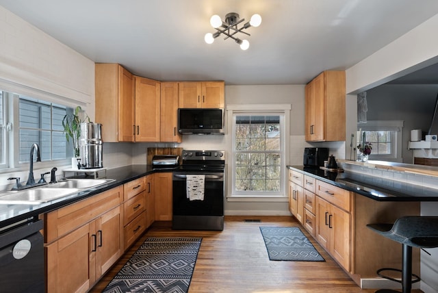 kitchen featuring dishwasher, electric range, a sink, and decorative backsplash