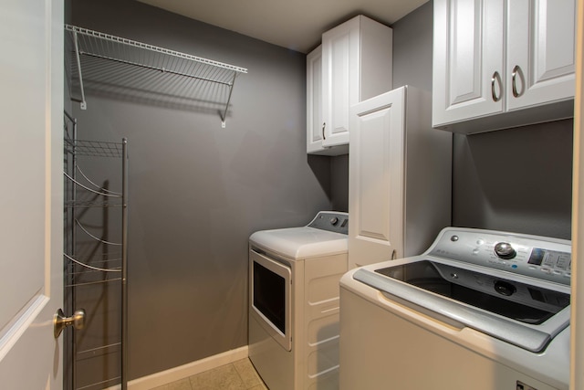 clothes washing area featuring cabinet space, independent washer and dryer, baseboards, and light tile patterned flooring