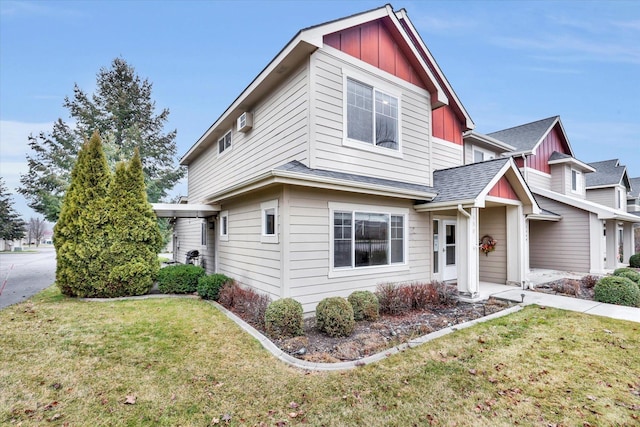 view of front of home featuring board and batten siding, a shingled roof, and a front lawn